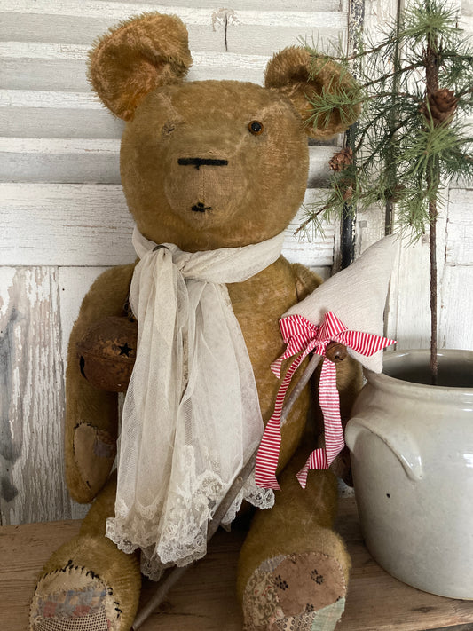 Large antique bear with linen tree.