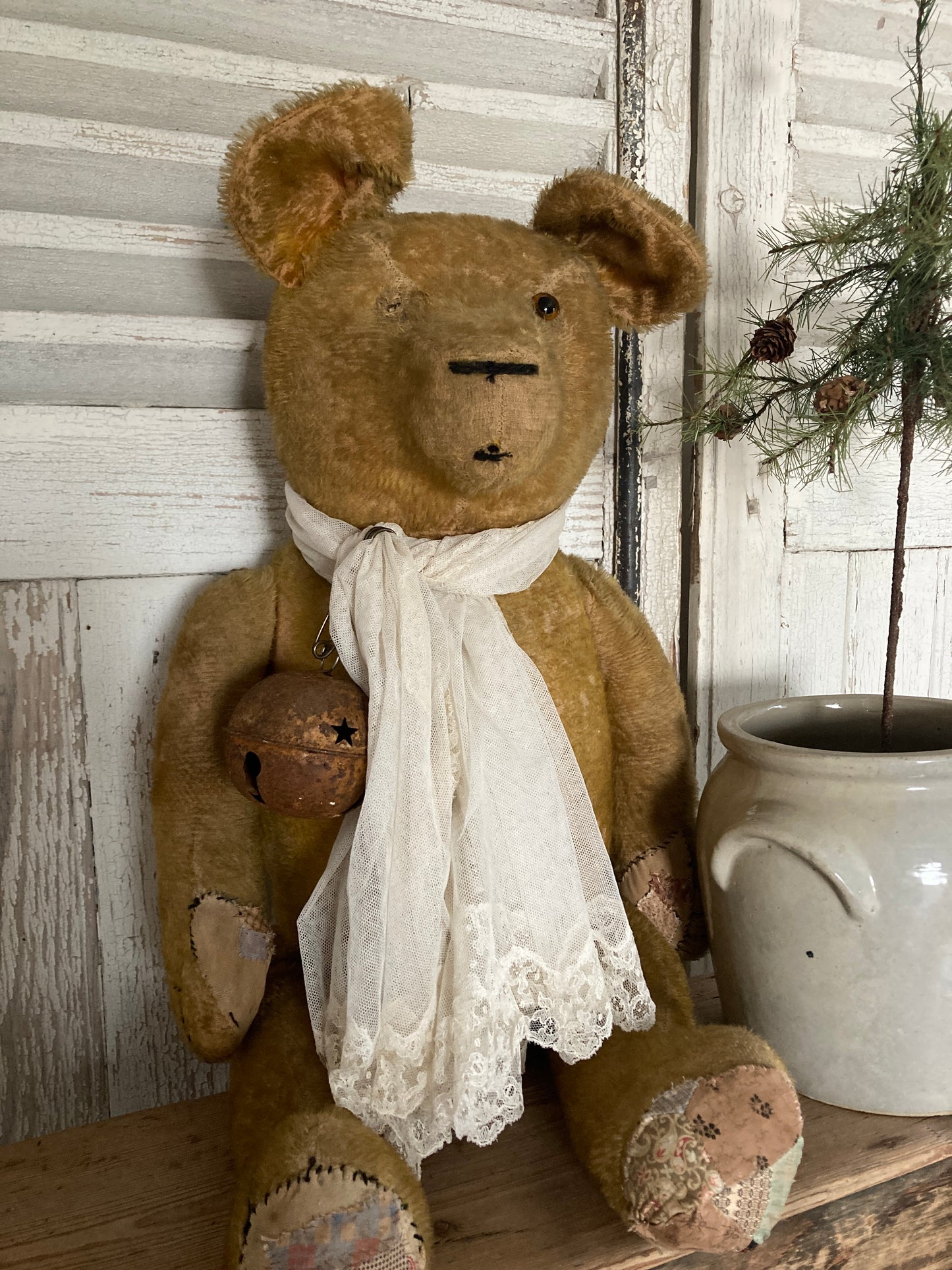 Large antique bear with linen tree.